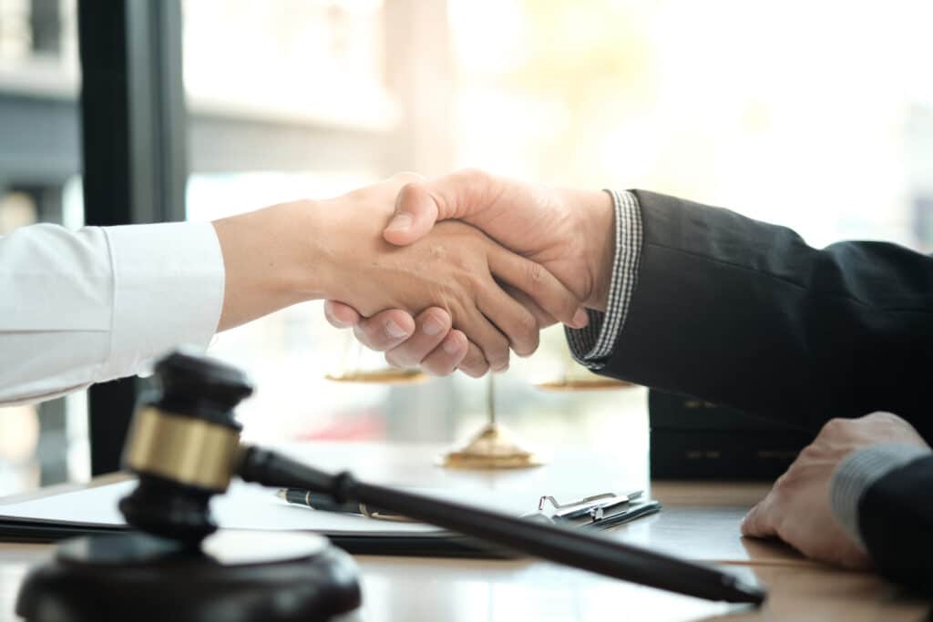 Lawyer handshake with client. Business partnership meeting successful concept.