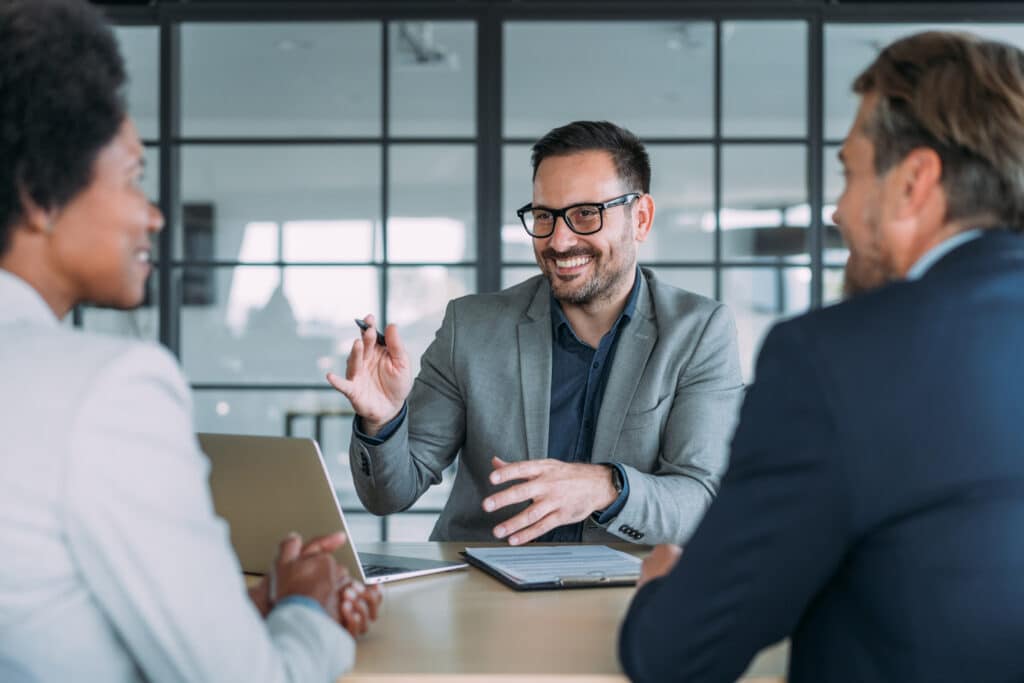 Group of business persons talking in the office.